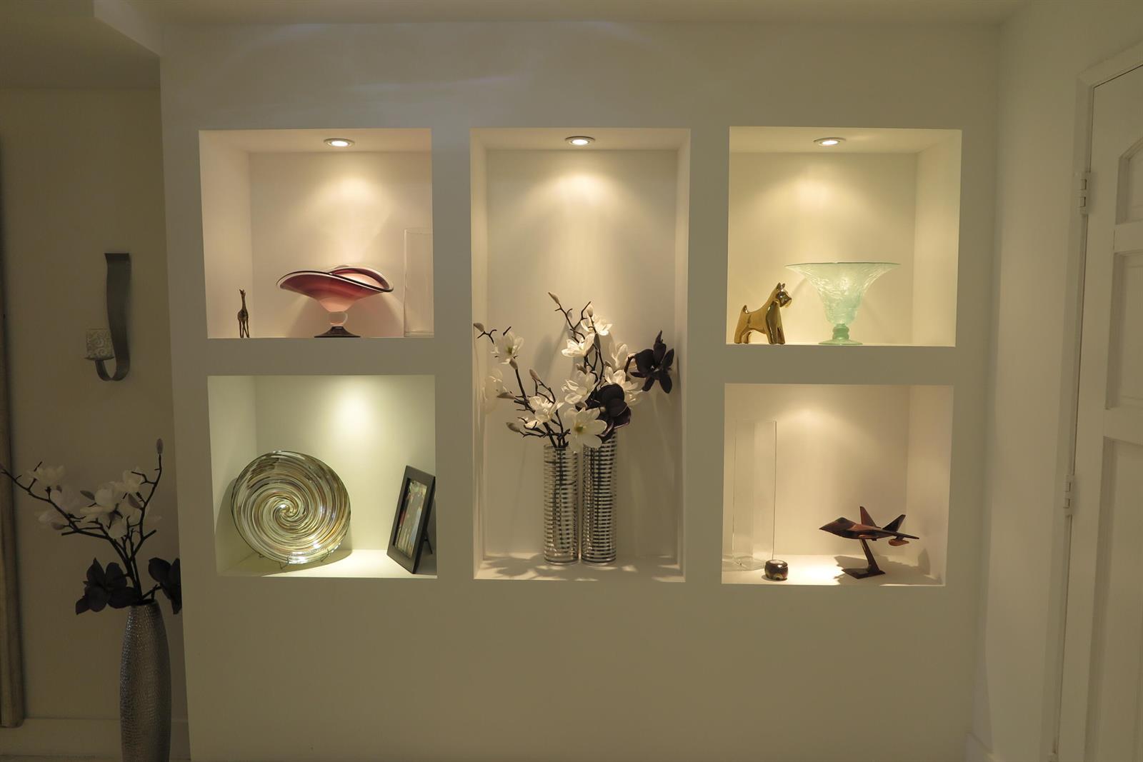 A white wall features three recessed niches with built-in spotlights displaying various decorative objects — 7875 La Mirada Drive, Boca Raton FL 33433, BOCA RATON, FL