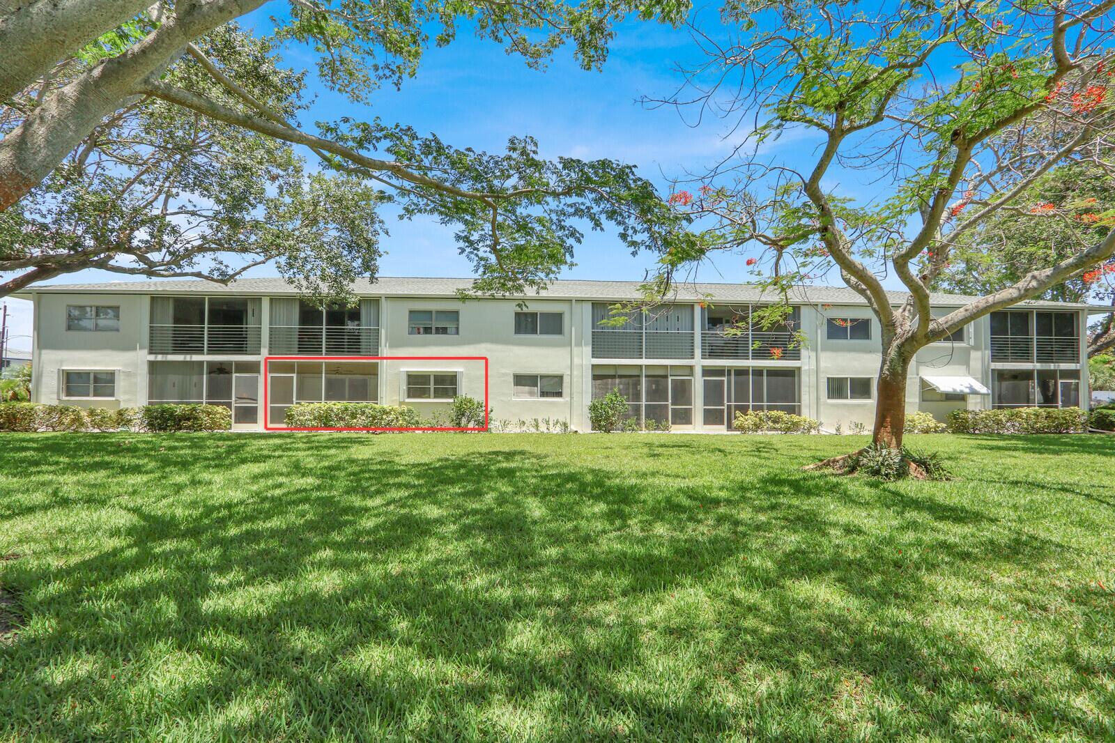 A multi-story apartment building exterior features a screened-in ground floor patio highlighted by a red box — 9 Westwood Avenue # 102b, Tequesta FL 33469, TEQUESTA, FL