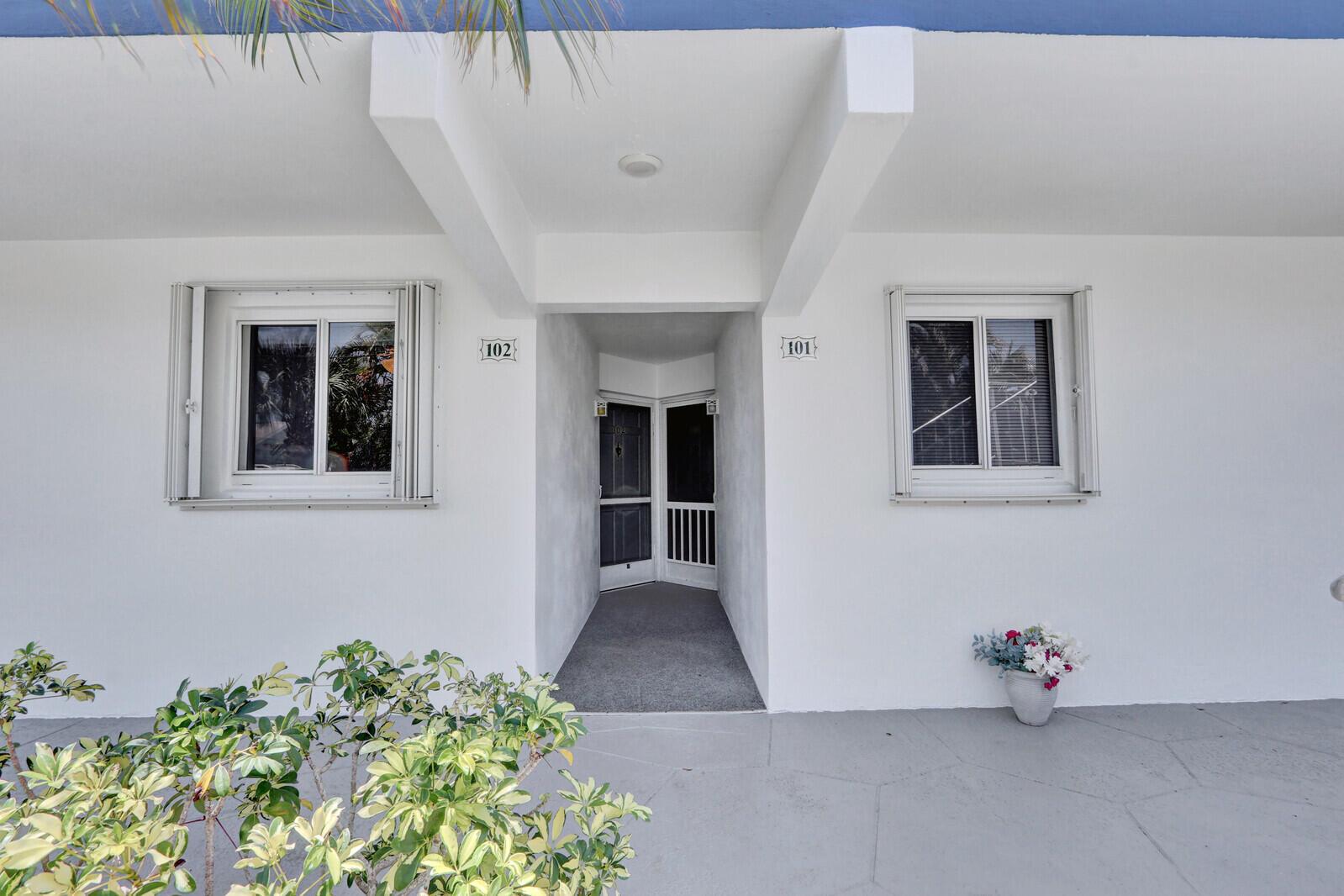The exterior of a white building shows two unit doors numbered 101 and 102 — 9 Westwood Avenue # 102b, Tequesta FL 33469, TEQUESTA, FL