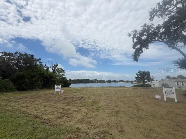 A vacant, grassy lot overlooks a lake under a cloudy sky — 0 SPIRIT LAKE ROAD, WINTER HAVEN, FL