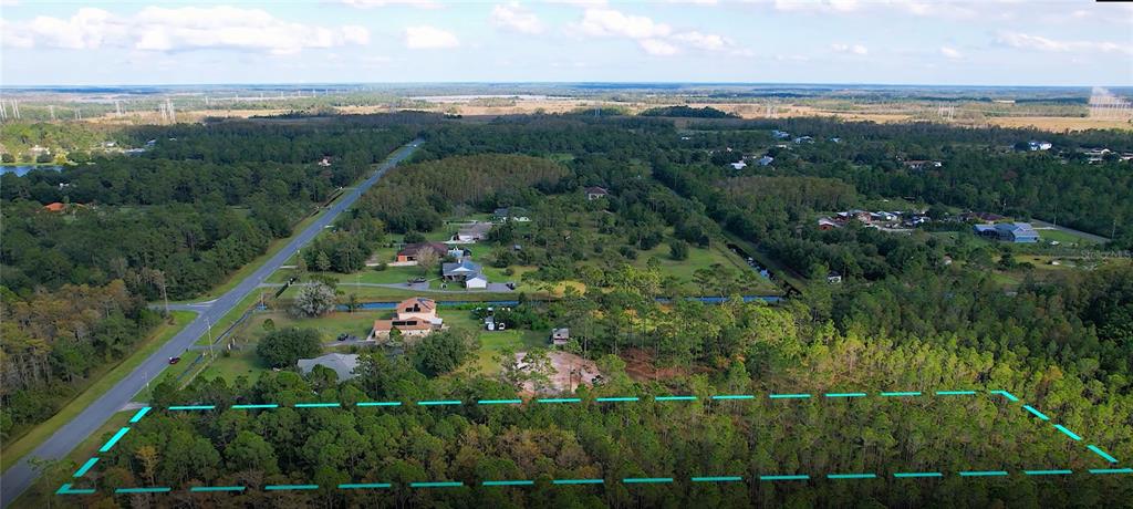 An aerial view shows a rectangular, wooded lot outlined in blue near a paved road — Lot 321 OBERLY PARKWAY, ORLANDO, FL