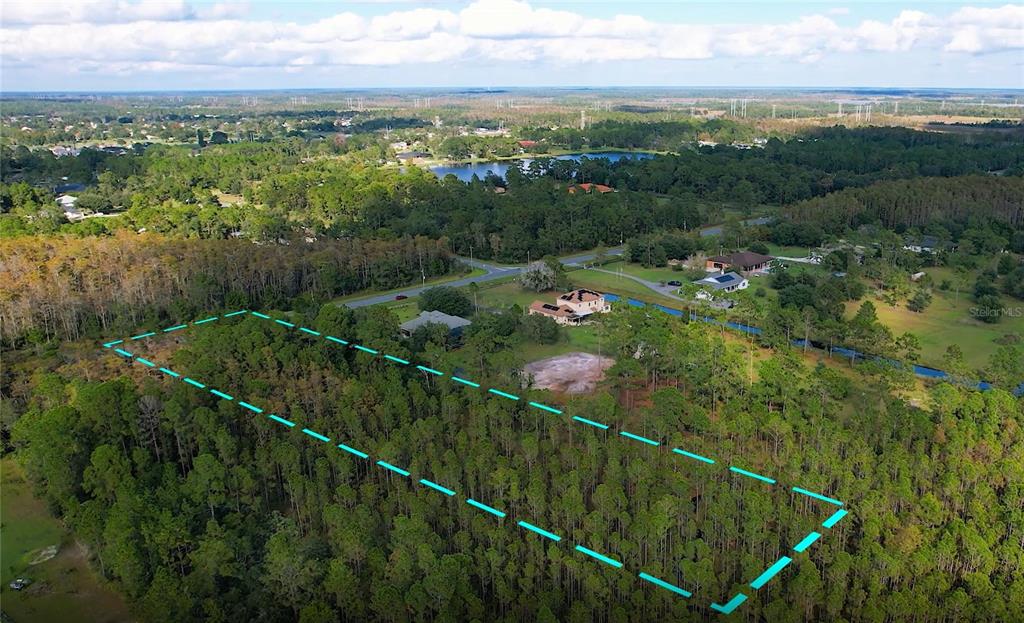 An aerial view shows a large, wooded plot of land outlined in blue — Lot 321 OBERLY PARKWAY, ORLANDO, FL