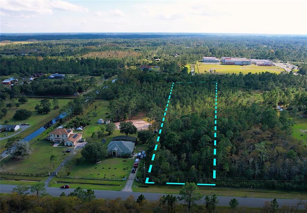 An aerial view shows a rectangular, wooded plot of land outlined in blue — Lot 321 OBERLY PARKWAY, ORLANDO, FL