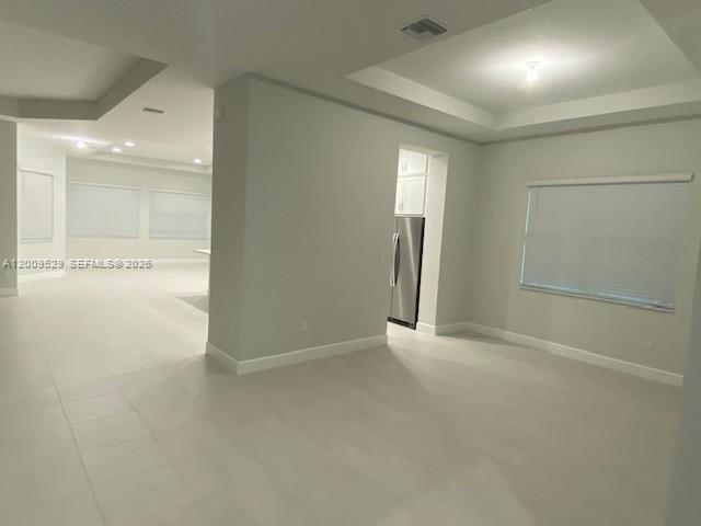 An interior view of a room with light-colored tile flooring, recessed lighting, and white walls — 4624 Citrus Blossom Ct, Westlake FL 33470, WESTLAKE, FL