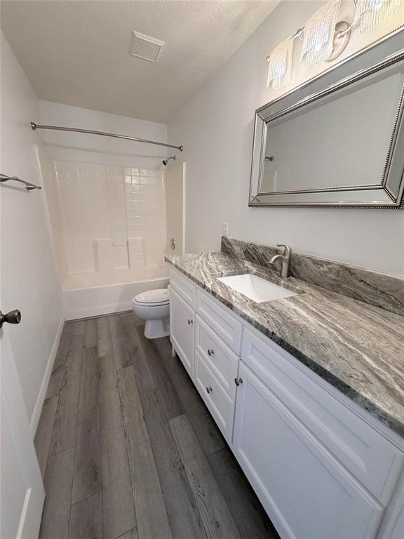 A bathroom features a white vanity with a stone countertop, a mirror, and a tub — 1088 NOMAD ROAD, PUNTA GORDA, FL