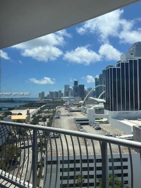 A balcony view overlooking a parking garage, city skyline, and a bridge over the water — 1750 N Bayshore Dr # 1714, Miami FL 33132, MIAMI, FL