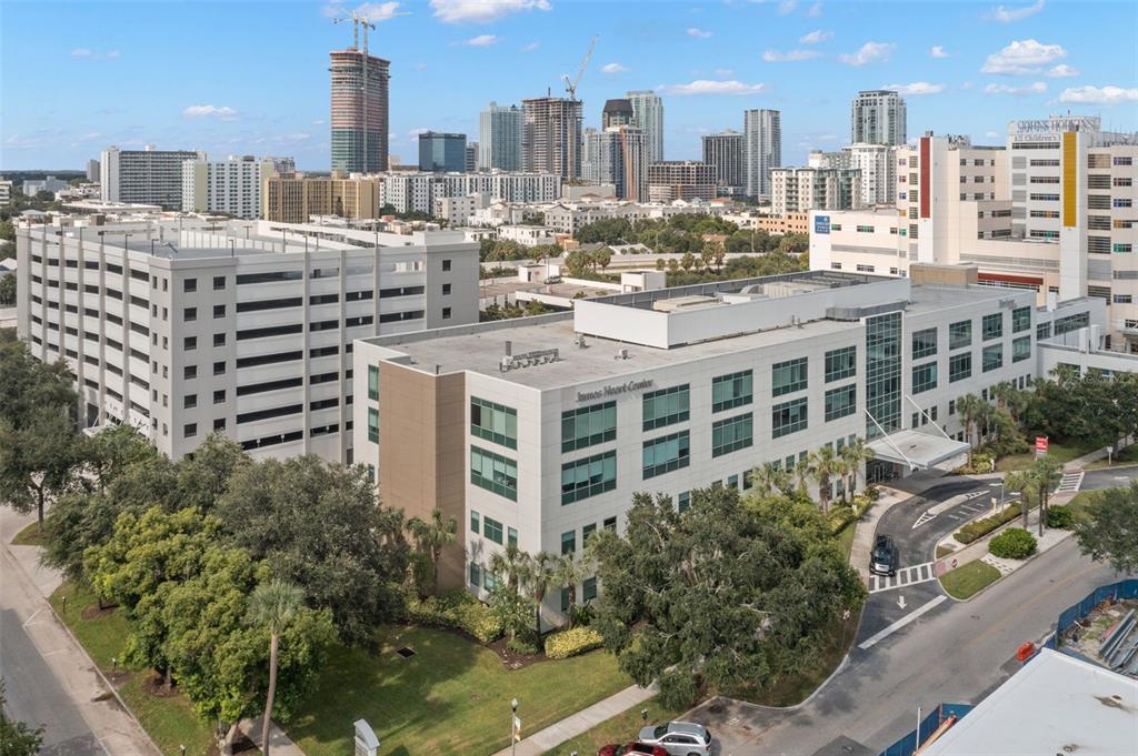 An aerial view shows a multi-story medical office building with an adjacent parking garage — 625 6TH AVENUE S UNIT 405, ST PETERSBURG, FL