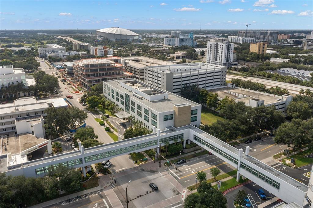 An aerial view of a multi-story office building connected by an elevated pedestrian walkway — 625 6TH AVENUE S UNIT 405, ST PETERSBURG, FL