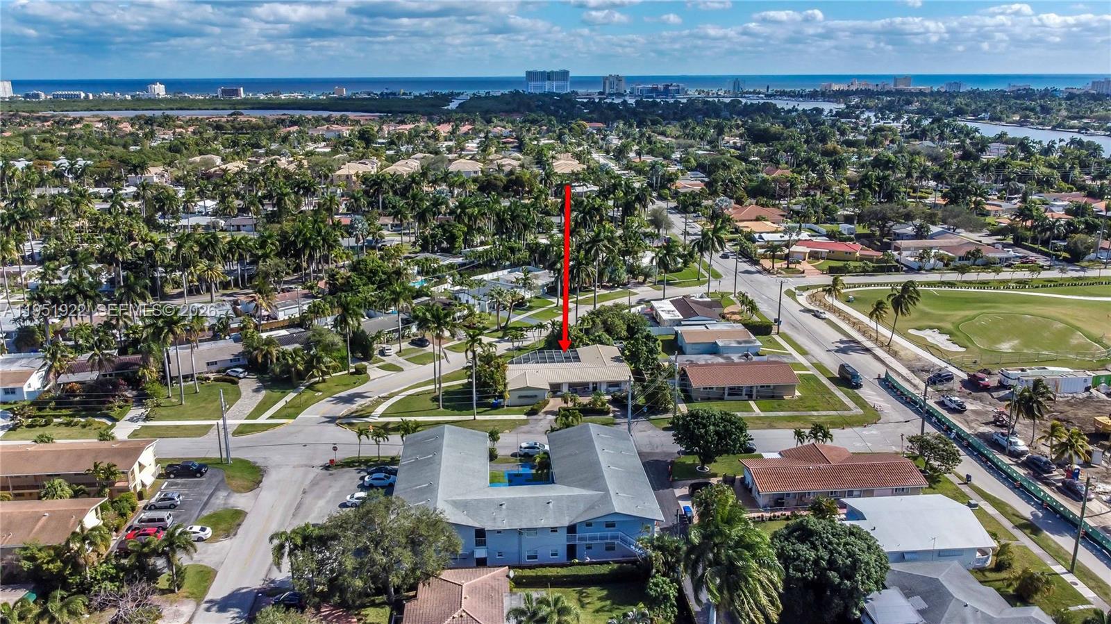 An aerial view shows a residential neighborhood with a red arrow pointing to a house — 910 N 14th Ct, Hollywood FL 33020, HOLLYWOOD, FL