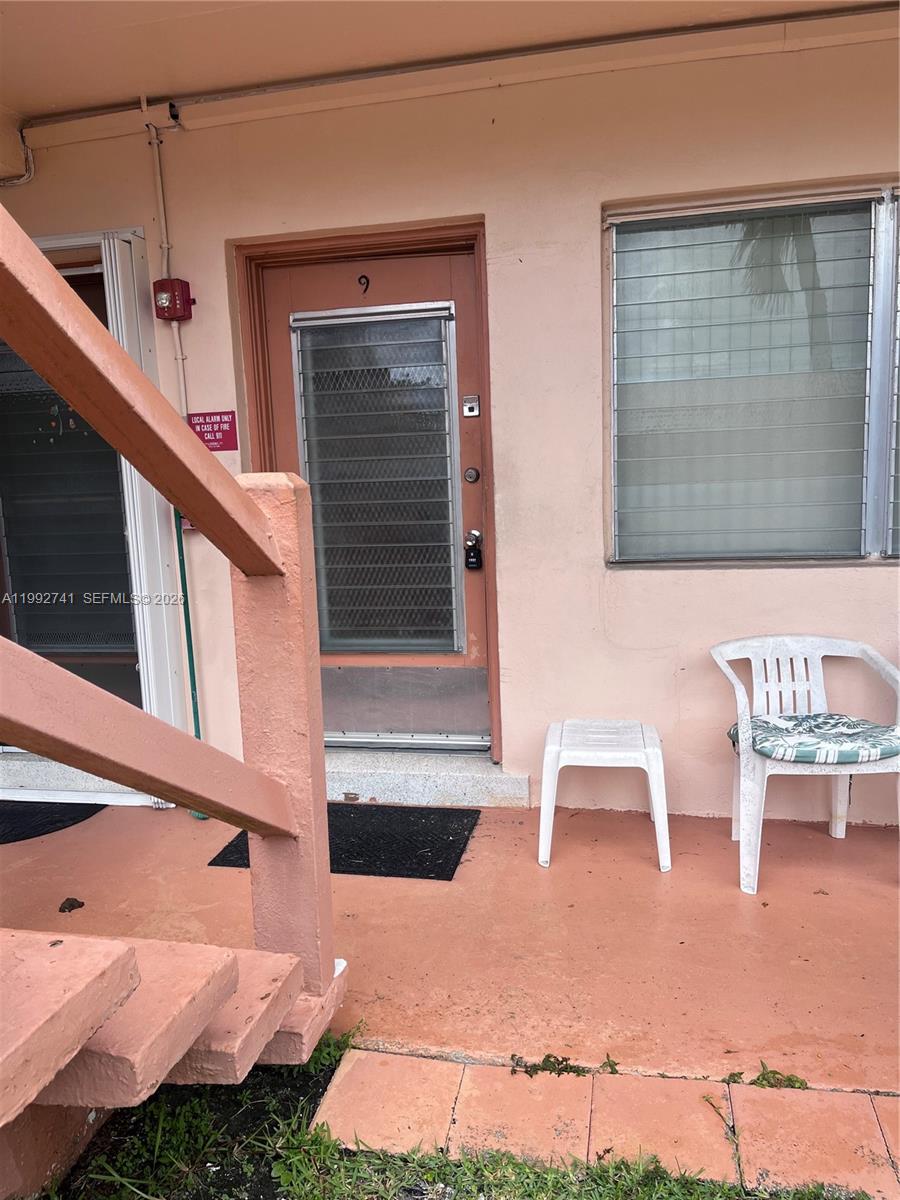 An exterior view of a building entrance with a door labeled nine and outdoor furniture — 1012 SW 11th St # 9N, Hallandale Beach FL 33009, HALLANDALE BEACH, FL