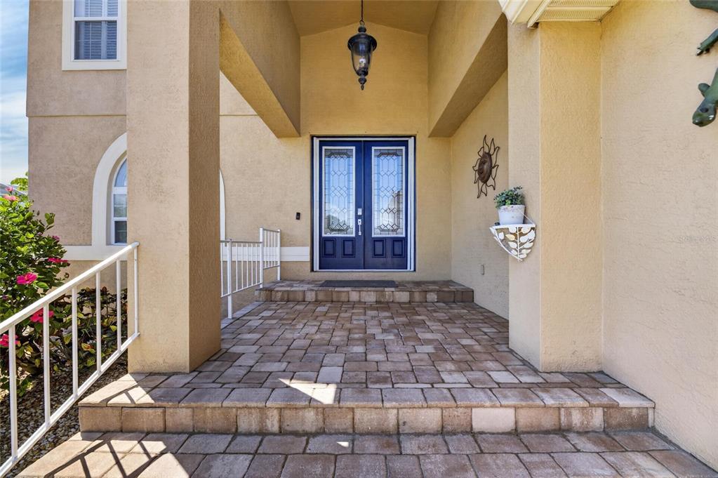 A two-story house with a three-car garage and a concrete driveway under a blue sky — 830 GOLF ISLAND DRIVE, APOLLO BEACH, FL