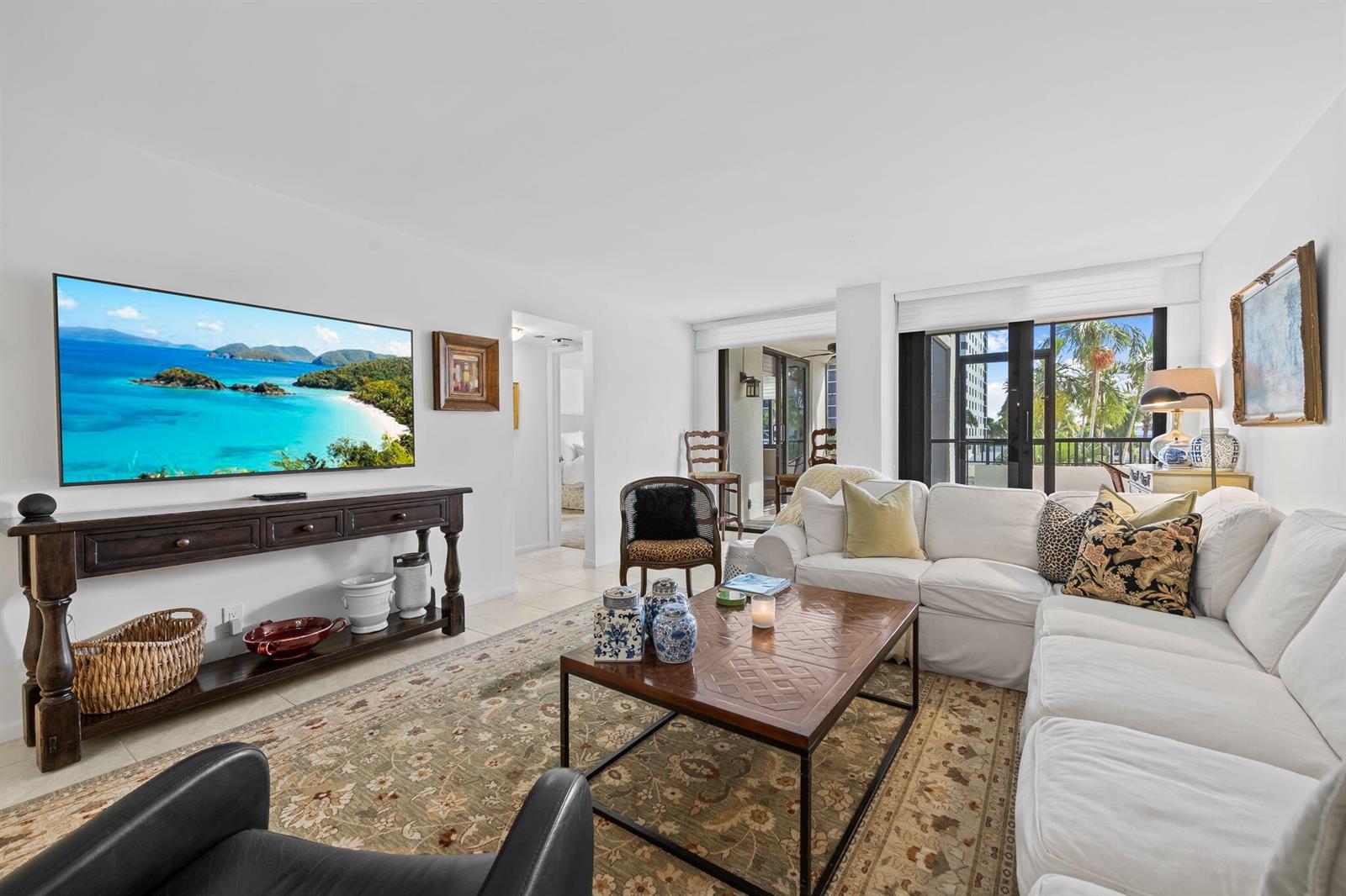 A dining area features a round wooden table, four chairs, and a decorative chandelier — 3420 S Ocean Boulevard # 3p, Highland Beach FL 33487, HIGHLAND BEACH, FL