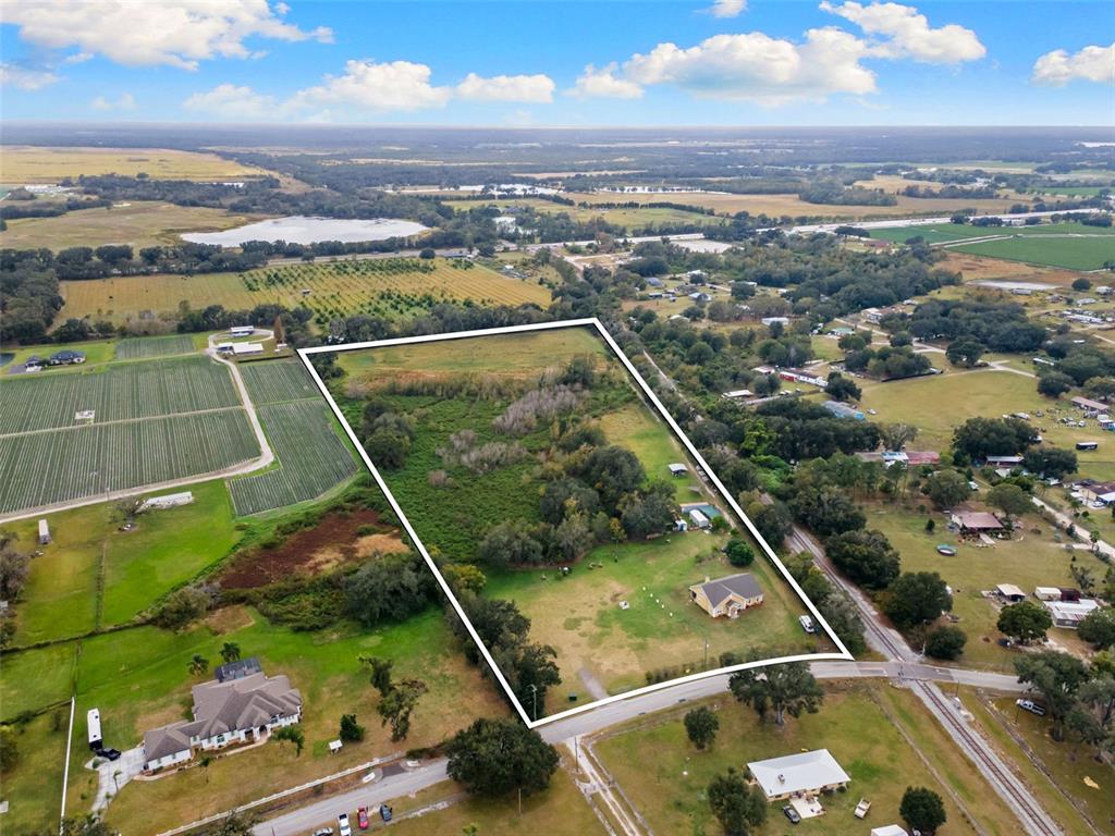 An aerial view shows a residential property outlined in white, featuring a house and trees — 1103 COLSON ROAD, PLANT CITY, FL
