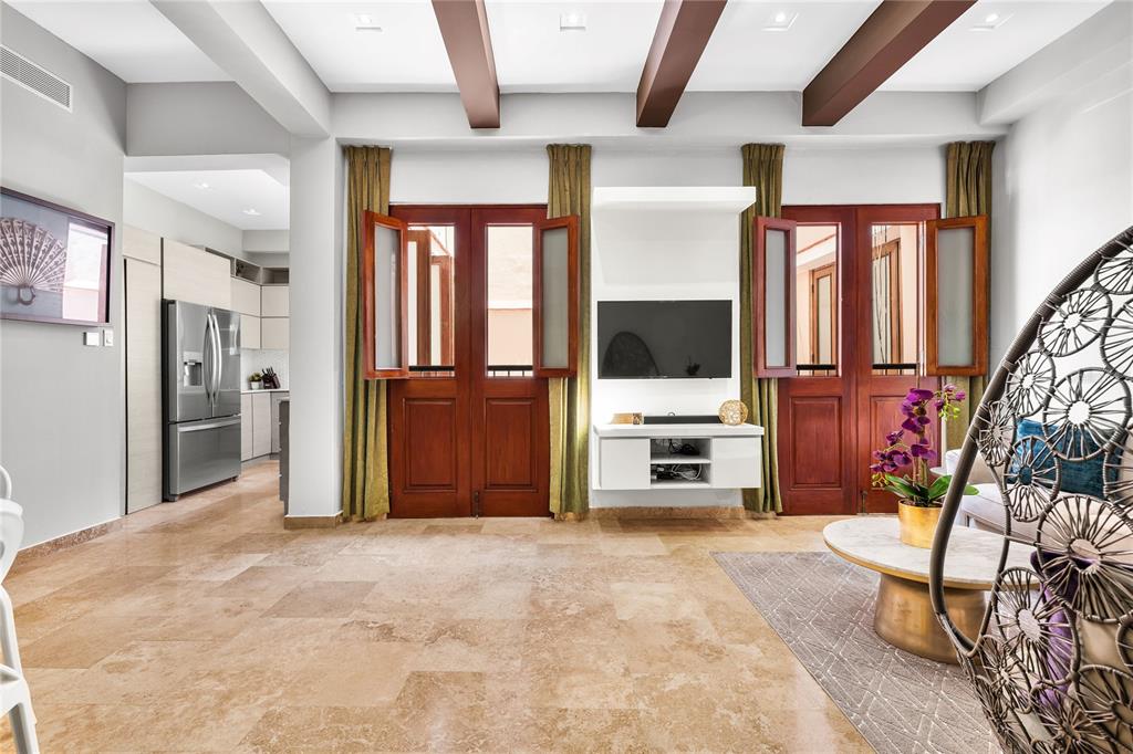 A living room features tile floors, wooden ceiling beams, and two sets of French doors — 311 LUNA ST UNIT 202, SAN JUAN, PR