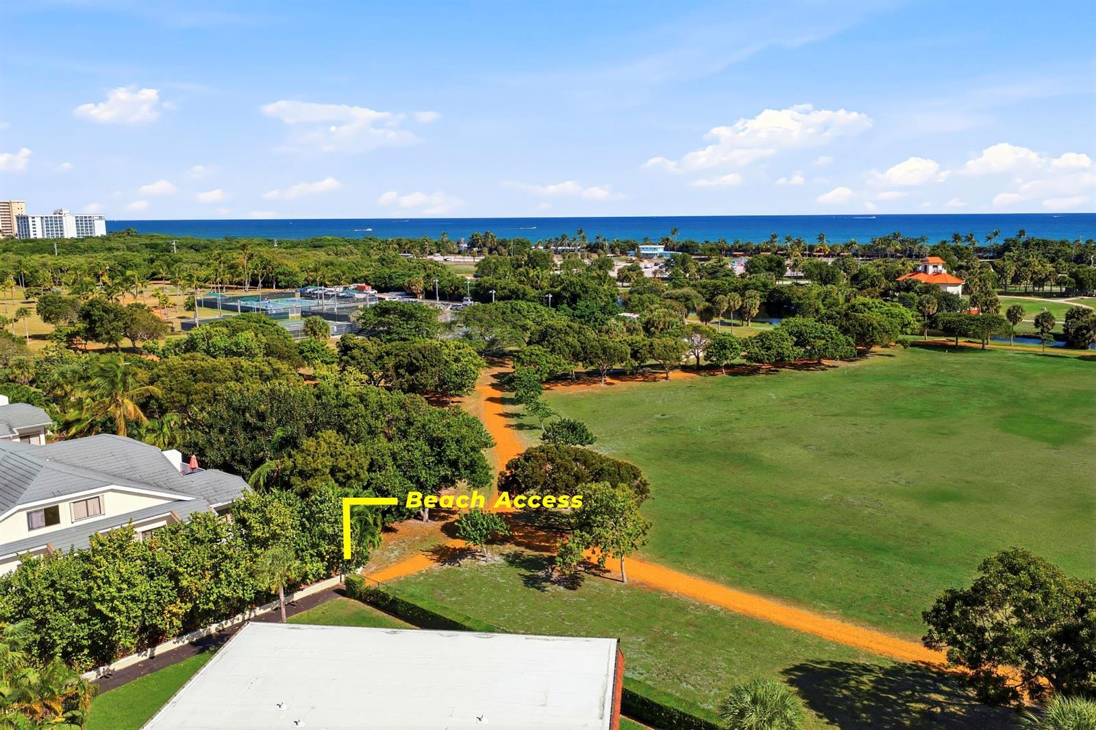 An aerial view shows a grassy park with a dirt path leading toward the ocean — 717 S Us Hwy 1 Unit 309, Jupiter FL 33477, JUPITER, FL