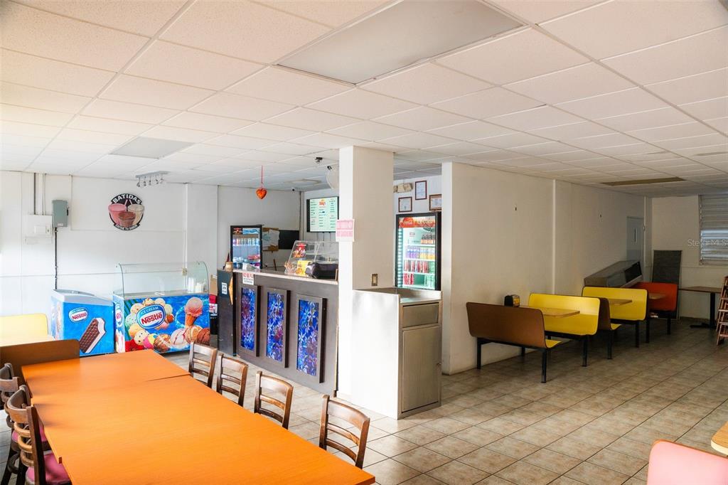 An interior view of a small restaurant featuring a service counter, seating, and tiled floors — #2 St. CARR. JUAQUIN “YIYE” AVILA, QUEBRADILLAS, PR