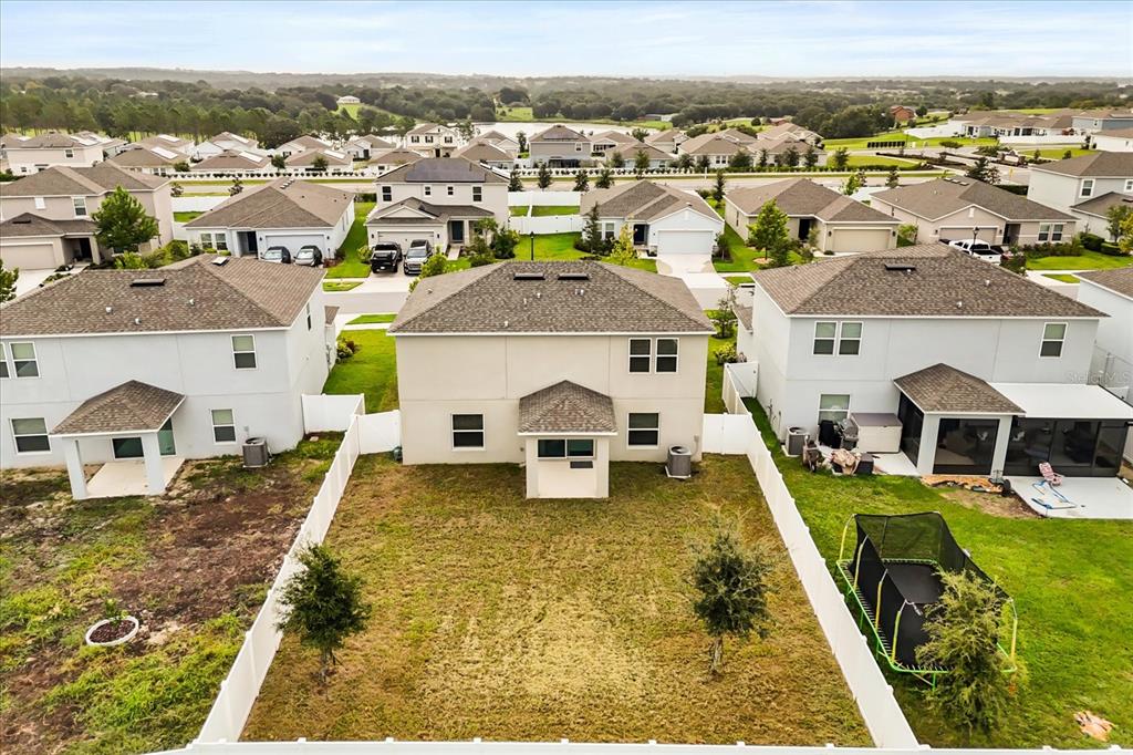 An aerial view of the rear exterior of a two-story house with a fenced yard — 1138 CALICO POINTE CIRCLE, GROVELAND, FL