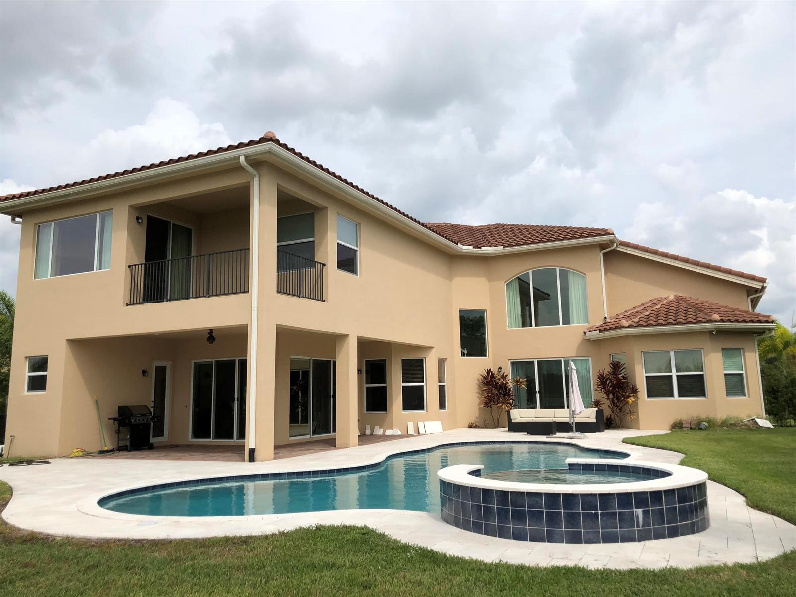 A two-story beige house with a tiled roof, swimming pool, and attached spa — 7793 Arbor Crest Way, West Palm Beach FL 33412, WEST PALM BEACH, FL