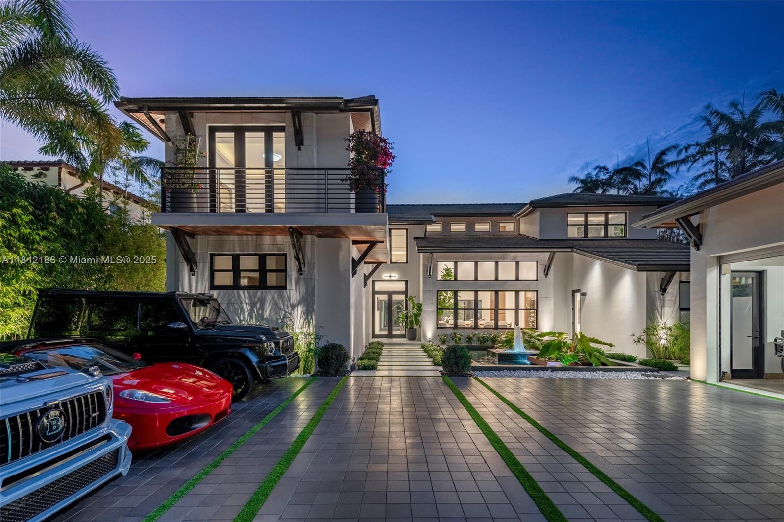 A modern two-story house exterior features a paved driveway, a fountain, and several luxury vehicles — 4241 Palm Ln, Miami FL 33137, MIAMI, FL