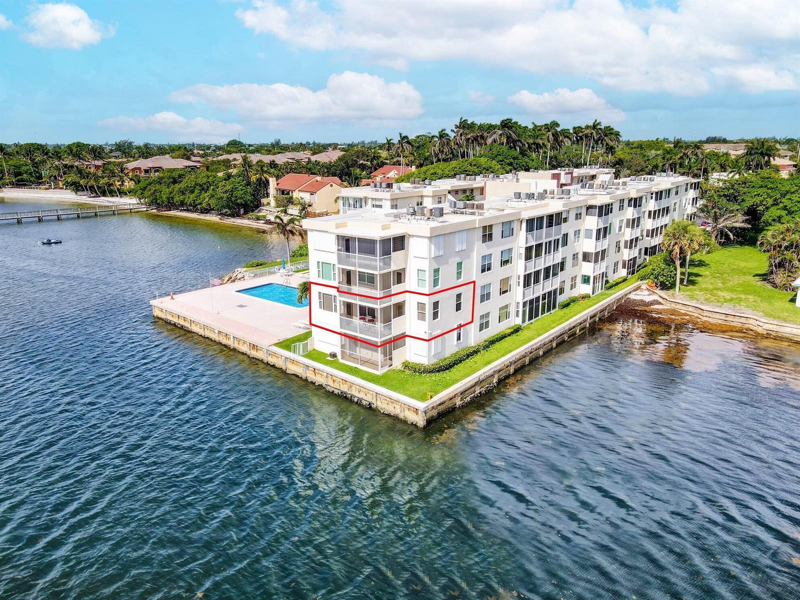 An aerial view of a waterfront apartment building with a red outline highlighting a unit — 1820 New Palm Way # 201, Boynton Beach FL 33435, BOYNTON BEACH, FL