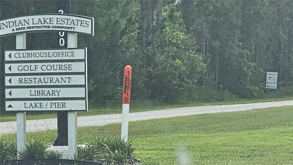 A sign for Indian Lake Estates stands beside a road near a wooded area — 1005 PLUMOSA DRIVE, INDIAN LAKE ESTATES, FL
