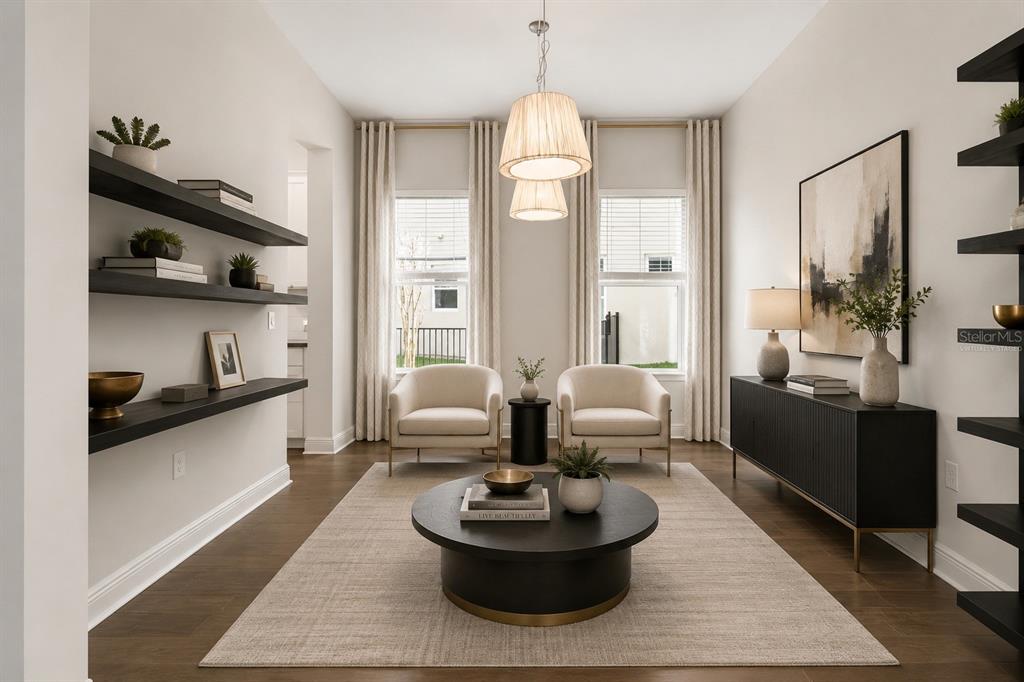 A living room features two cream chairs, a round coffee table, and dark floating shelves — 8724 PEACHTREE PARK COURT, WINDERMERE, FL