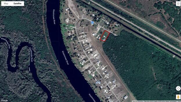 This satellite map shows a residential lot highlighted in red near the Kissimmee River — 19720 NW 94th Drive, Okeechobee FL 34972, OKEECHOBEE, FL