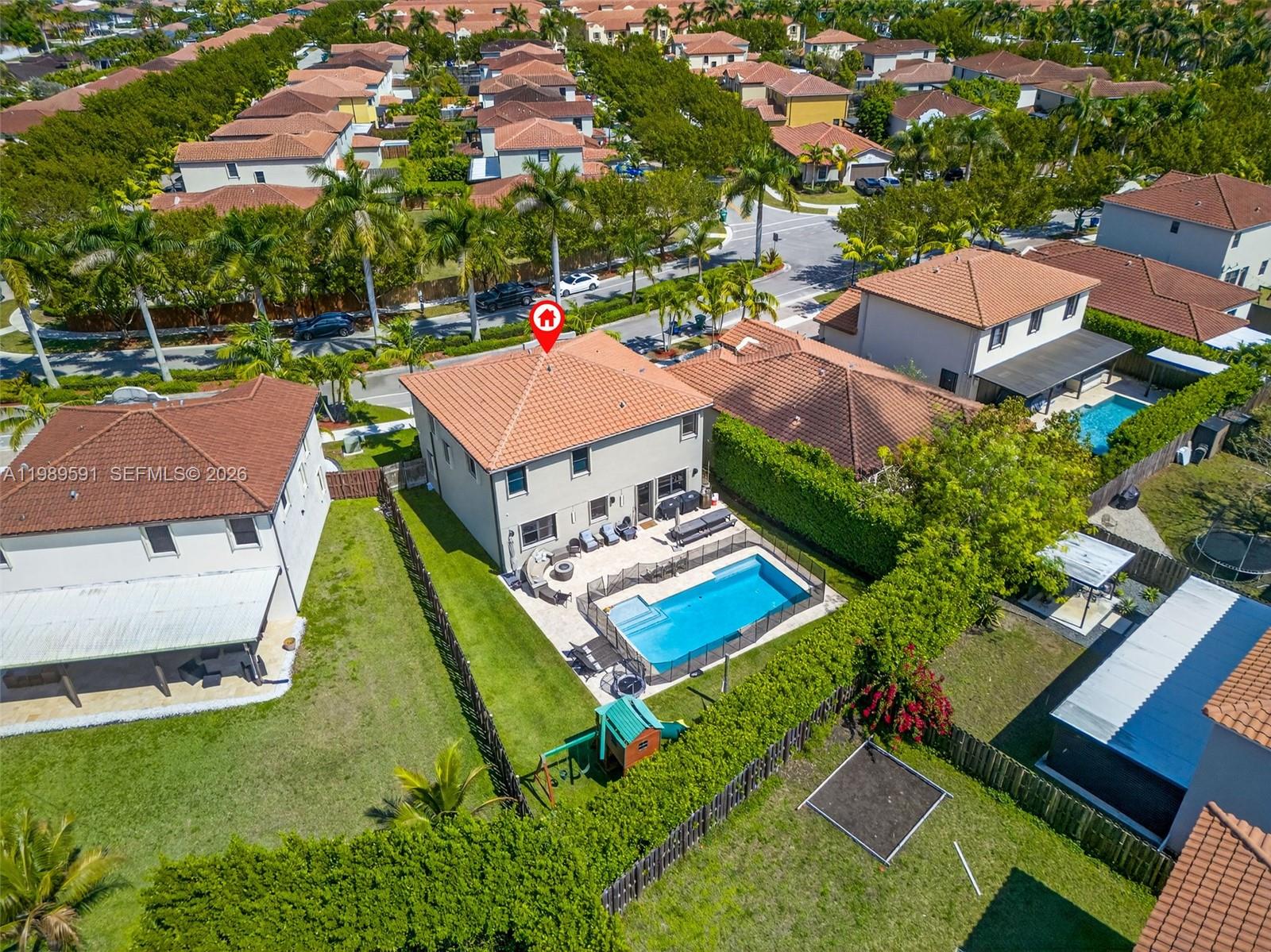 An aerial view shows a two-story house with a swimming pool and fenced backyard — 17340 SW 154th Pl, Miami FL 33187, MIAMI, FL
