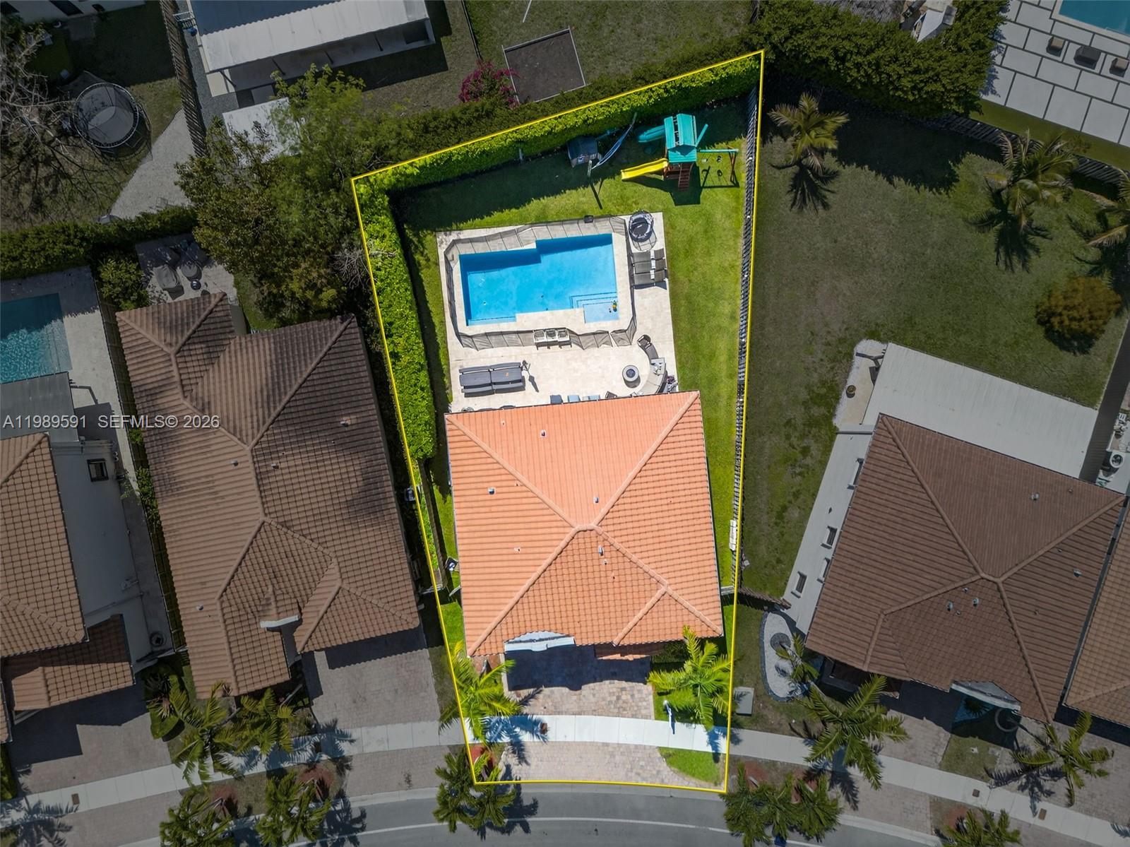 An aerial view shows a house with a tiled roof, a pool, and a fenced yard — 17340 SW 154th Pl, Miami FL 33187, MIAMI, FL