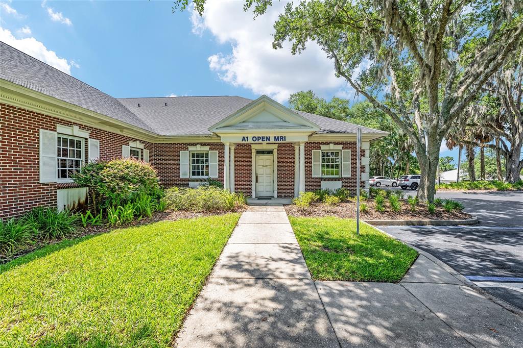 A brick medical office building features a white front entrance with a pedimented portico — 301 SE 17TH STREET UNIT 2, OCALA, FL