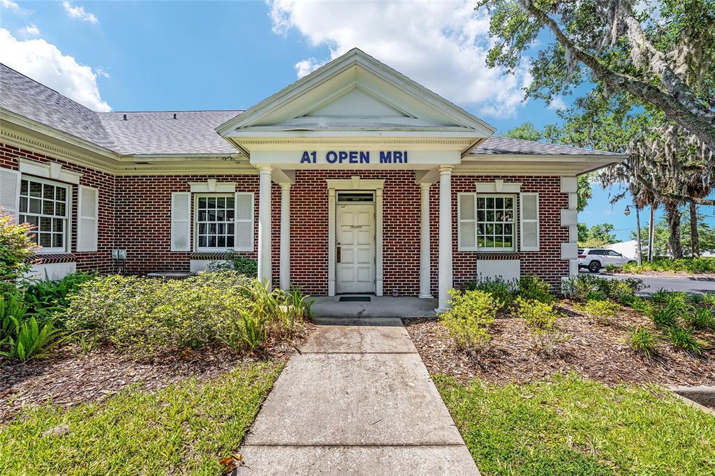 A brick building with a white front entrance and a sign reading A1 OPEN MRI — 301 SE 17TH STREET UNIT 2, OCALA, FL