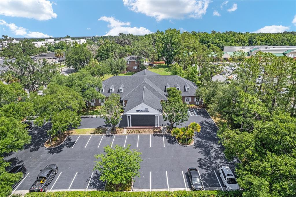 An aerial view of a brick office building with a dark shingled roof and parking — 301 SE 17TH STREET UNIT 2, OCALA, FL