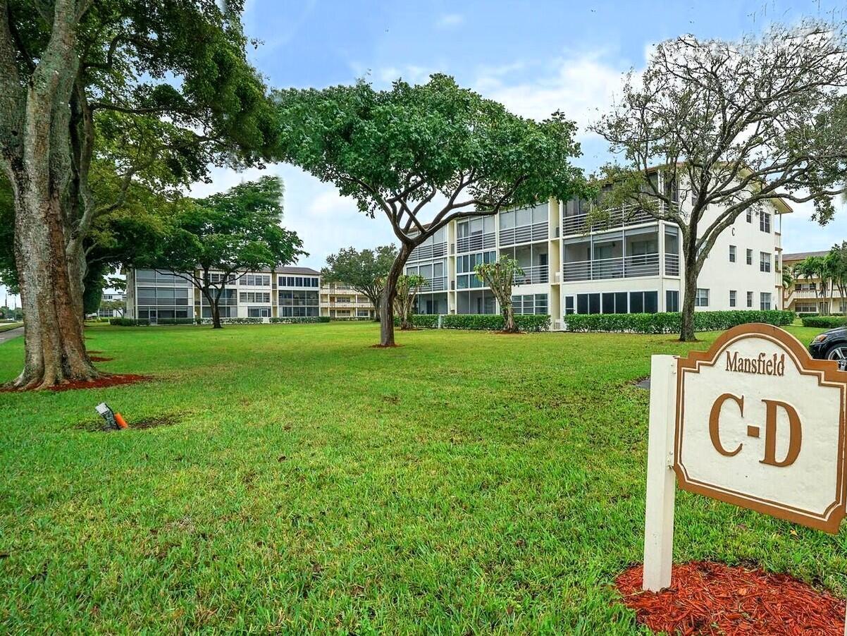 A sign labeled Mansfield C-D stands on a lawn in front of two apartment buildings — 99 Mansfield C # 99, Boca Raton FL 33434, BOCA RATON, FL