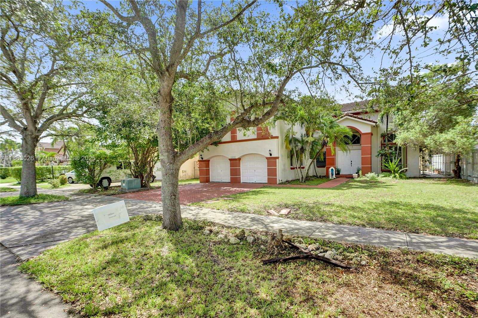 A two-story house with a two-car garage and a red brick driveway — 14824 SW 180th St, Miami FL 33187, MIAMI, FL