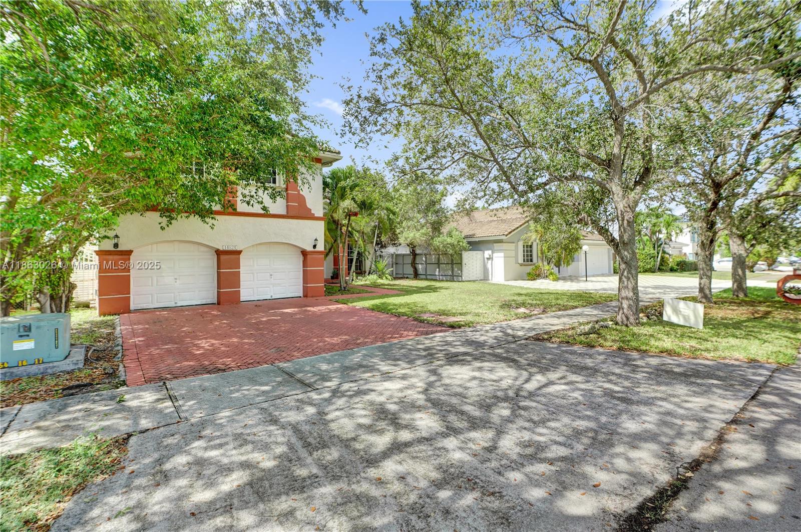 A two-story house with a red-brick driveway and a two-car garage — 14824 SW 180th St, Miami FL 33187, MIAMI, FL