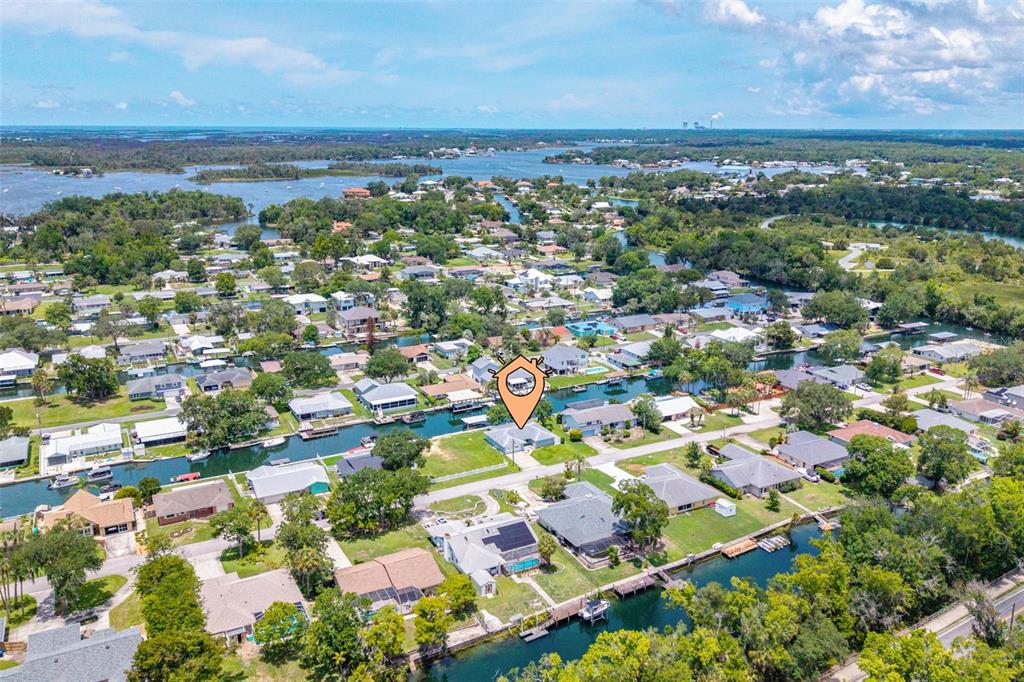 An aerial view shows a residential neighborhood with houses situated along interconnected canals — 1218 SE 5TH AVENUE, CRYSTAL RIVER, FL