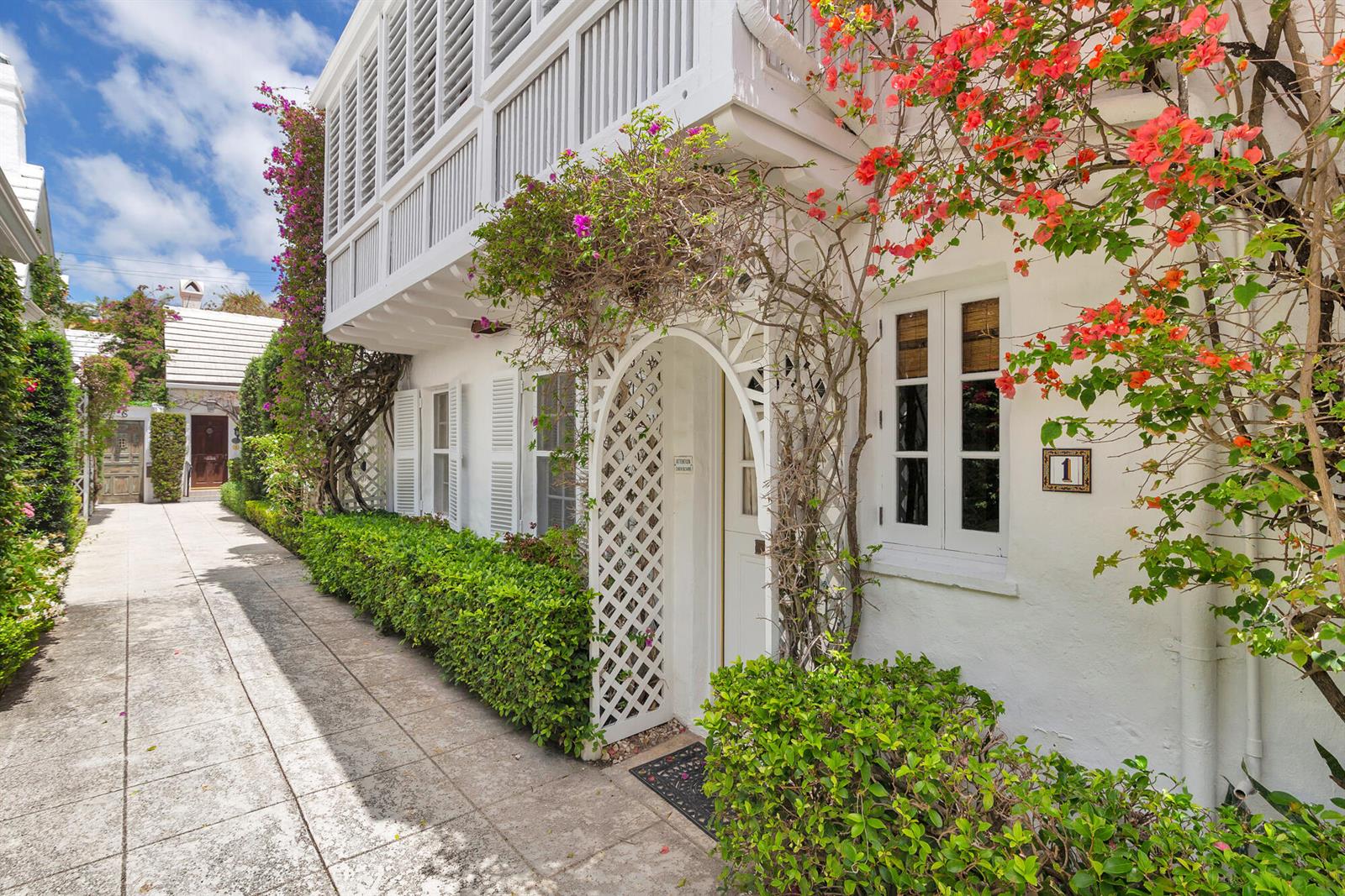 A white building with a lattice archway, bougainvillea, and a walkway leading to a doorway — 417 Peruvian Avenue # 1, Palm Beach FL 33480, PALM BEACH, FL