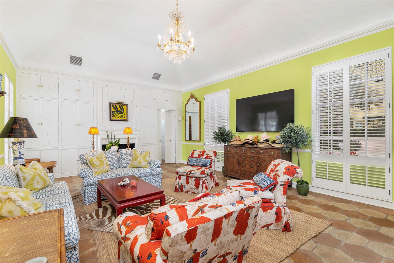 A living room features lime green walls, white built-in cabinetry, a chandelier, and patterned furniture — 417 Peruvian Avenue # 1, Palm Beach FL 33480, PALM BEACH, FL