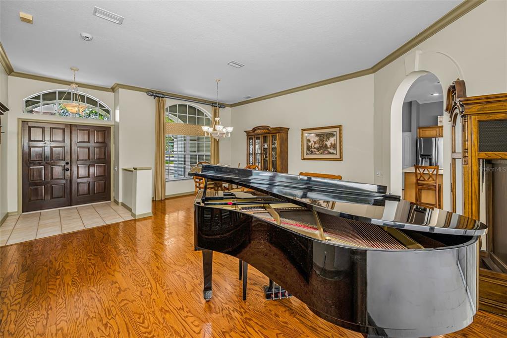 A gray stucco house with a curved walkway and landscaped garden beds — 4084 LIGUSTRUM DRIVE, PALM HARBOR, FL