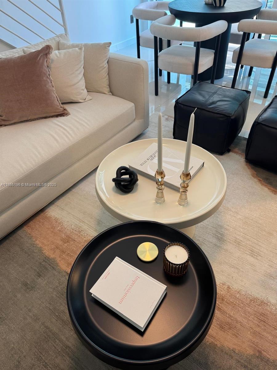 A living room features a cream sofa, two round coffee tables, and a dining area — 60 SW 13th St # 1406, Miami FL 33130, MIAMI, FL