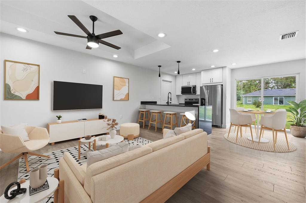 This is a virtual staging rendering of an open-concept living room and kitchen area — 9590 W TENNESSEE LANE, CRYSTAL RIVER, FL