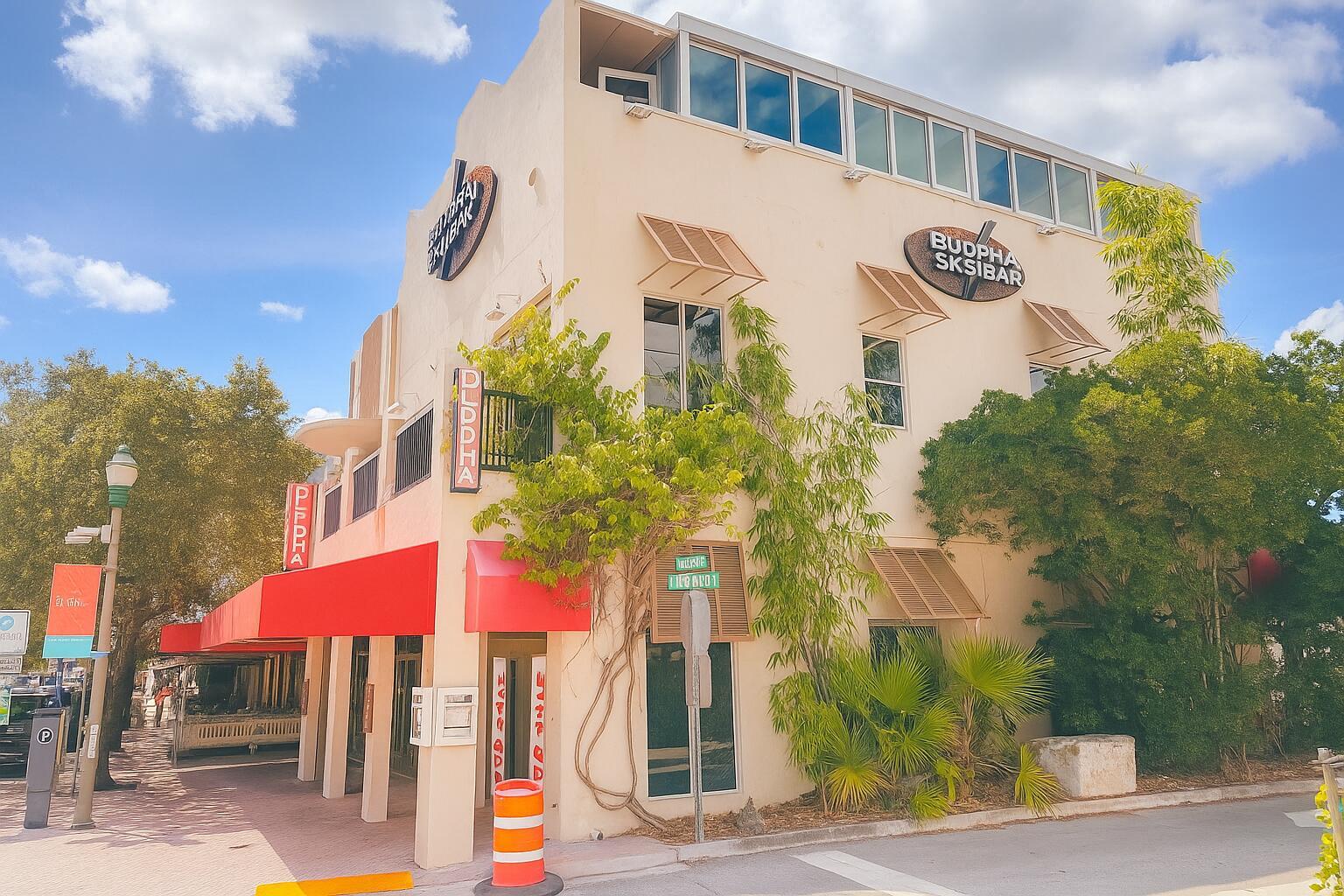 A three-story beige building with a red awning and signage for Budpha Sksibar — 217 E Atlantic Avenue, Delray Beach FL 33444, DELRAY BEACH, FL