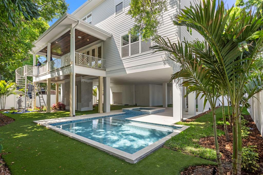 A multi-story house with a raised deck, spiral staircase, and an in-ground pool and spa — 2312 S OCCIDENT STREET, TAMPA, FL
