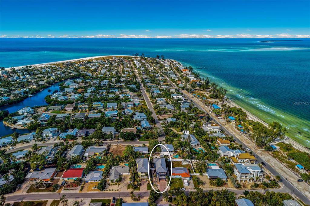 An aerial view shows a coastal neighborhood with a white oval highlighting a specific house — 159 CRESCENT DRIVE, ANNA MARIA, FL