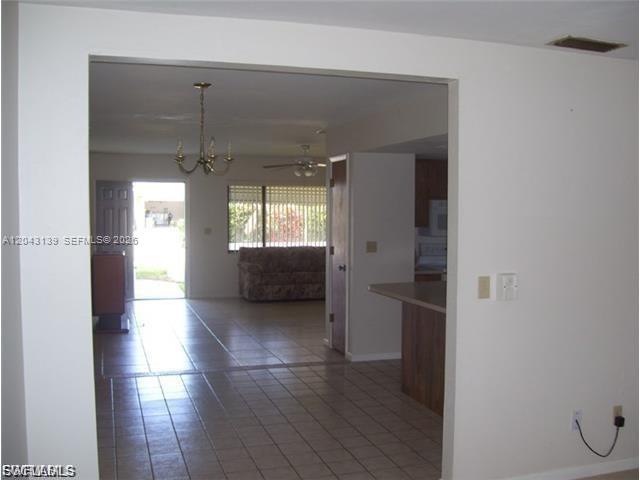 A view from a tiled room looking through a doorway into a living area — 4619 SW 7TH PL, Cape Coral FL 33914, CAPE CORAL, FL