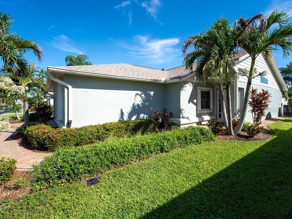 A single-story house with a light-colored exterior, a shingled roof, and palm trees in front — 4322 EDENROSE WAY UNIT 86, SARASOTA, FL