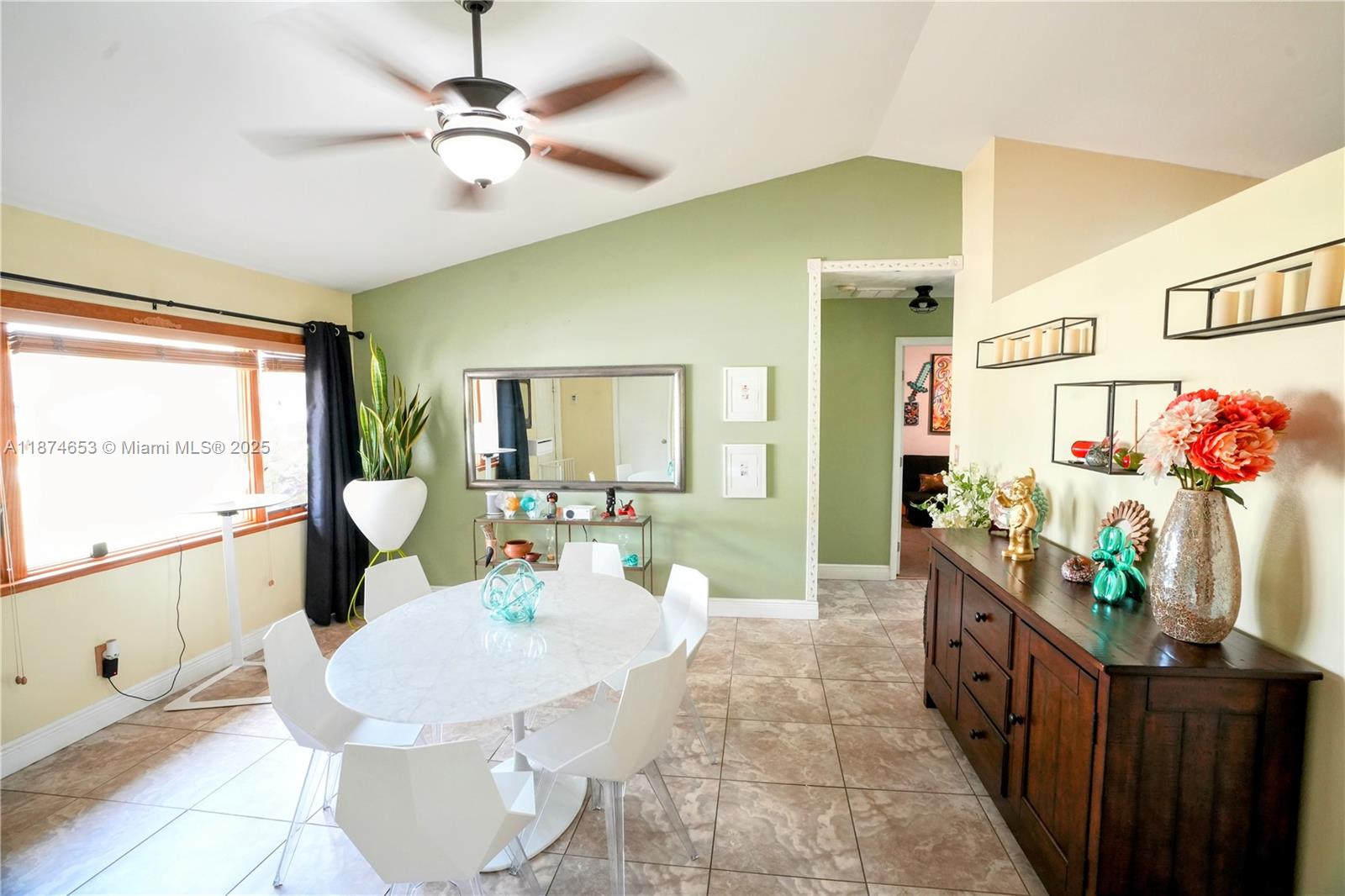 A dining room features a white oval table, modern chairs, and a dark wood sideboard — 2304 SE 8TH TER, Cape Coral FL 33990, CAPE CORAL, FL