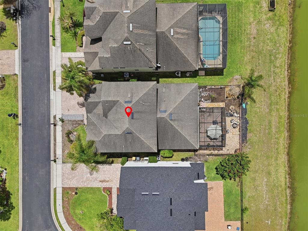 An aerial view shows three residential houses with pools and a nearby road — 1409 BROOKHAVEN COURT, DAVENPORT, FL
