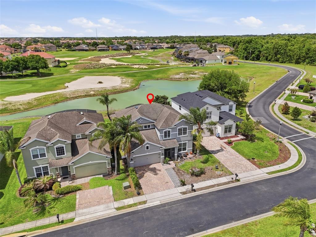 An aerial view shows a two-story gray house with a red map pin marker — 1409 BROOKHAVEN COURT, DAVENPORT, FL
