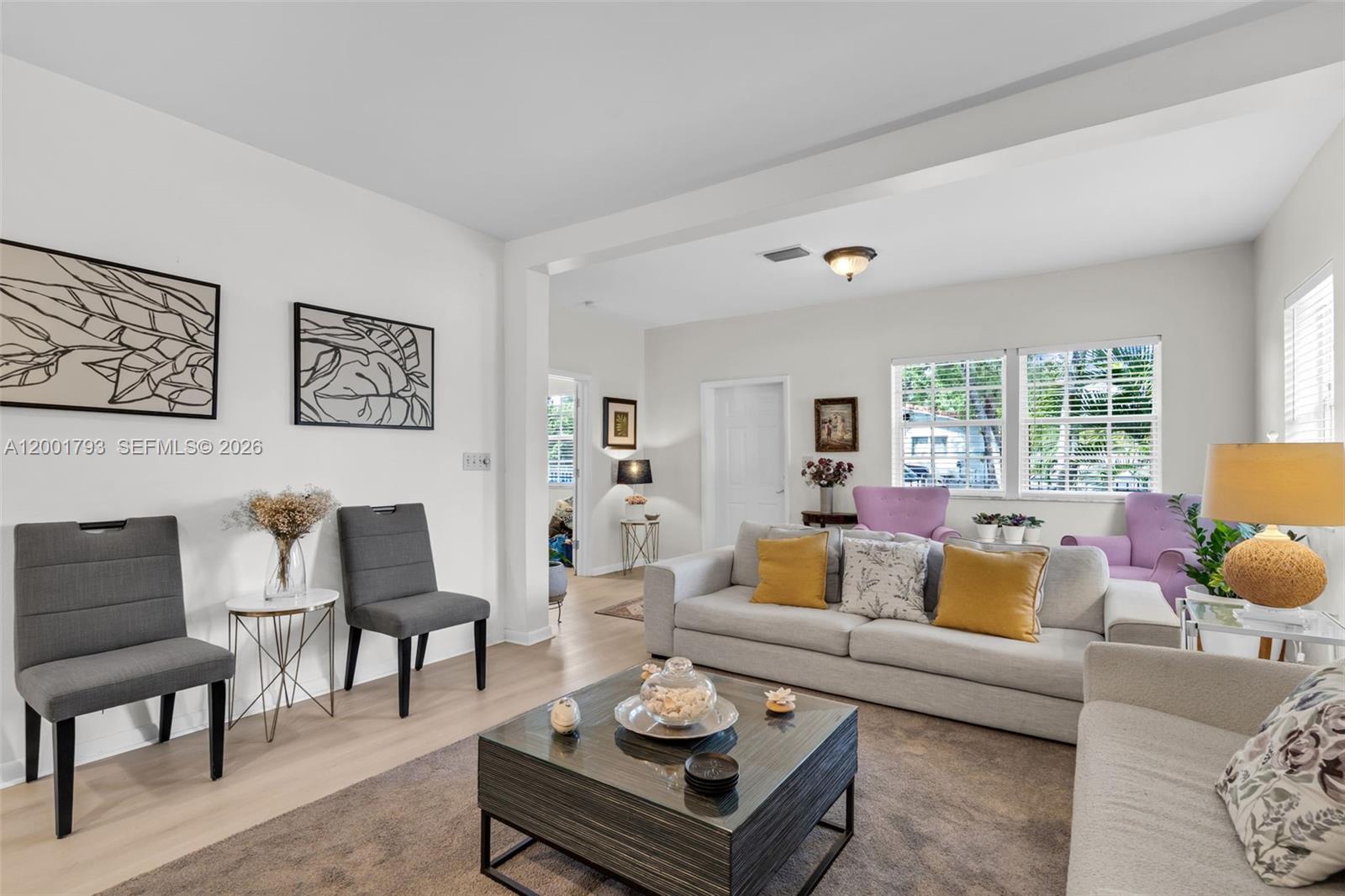 A living room features a gray sofa, two gray chairs, and a square coffee table — 7611 NW 3rd Ave, Miami FL 33150, MIAMI, FL